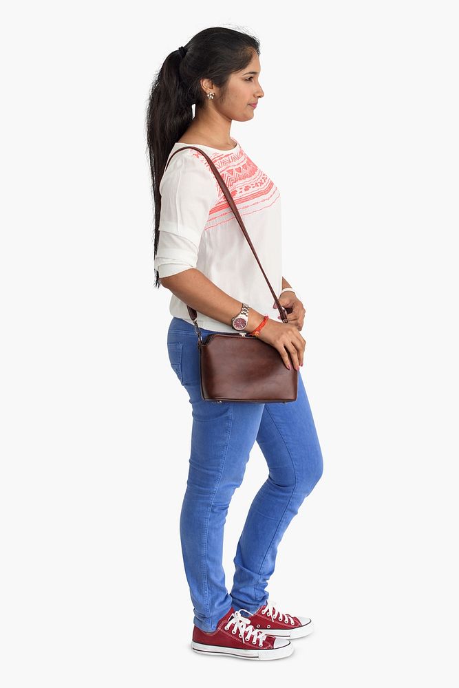 Casual young woman standing carrying her bag
