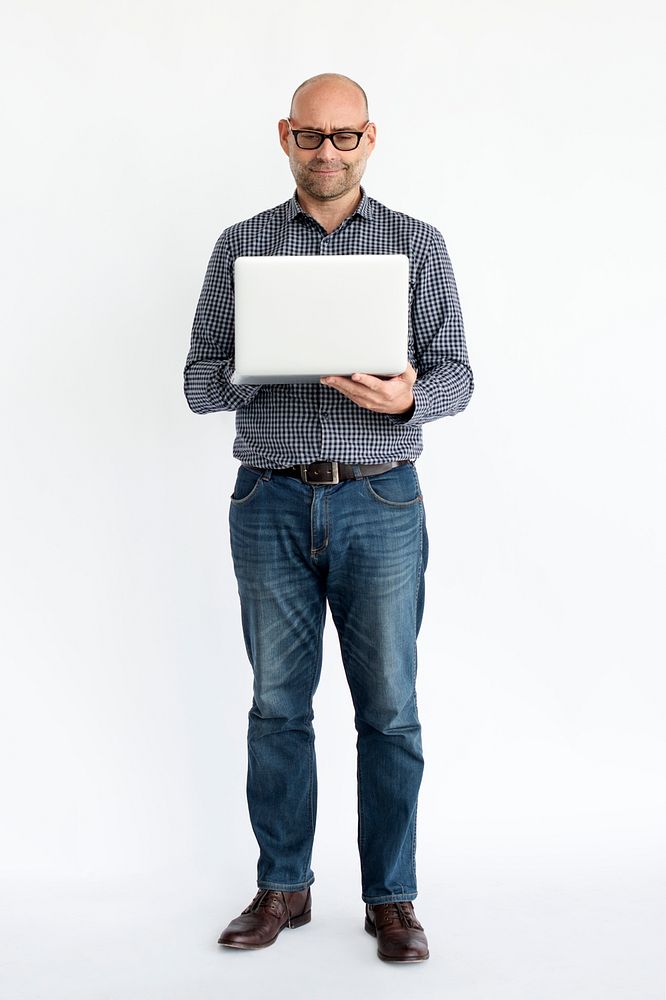 Mature guy using laptop full body portrait