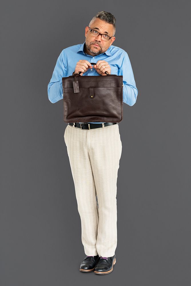 Whole body portrait of an apologetic man holding his bag