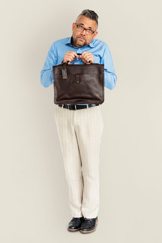 Whole body portrait of an apologetic man holding his bag
