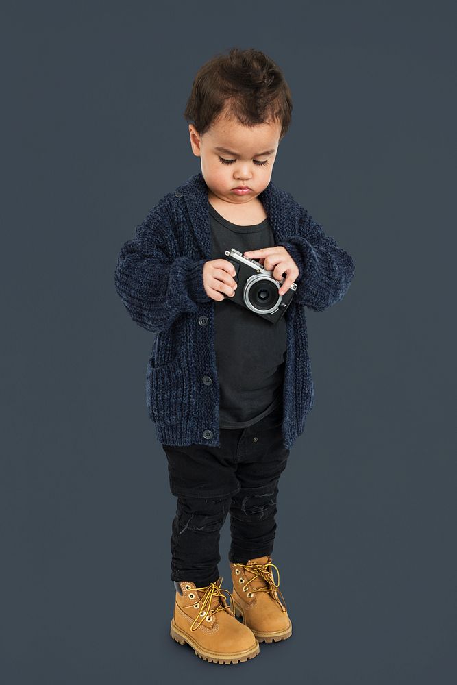 Curious Little Boy Holding Camera Concept