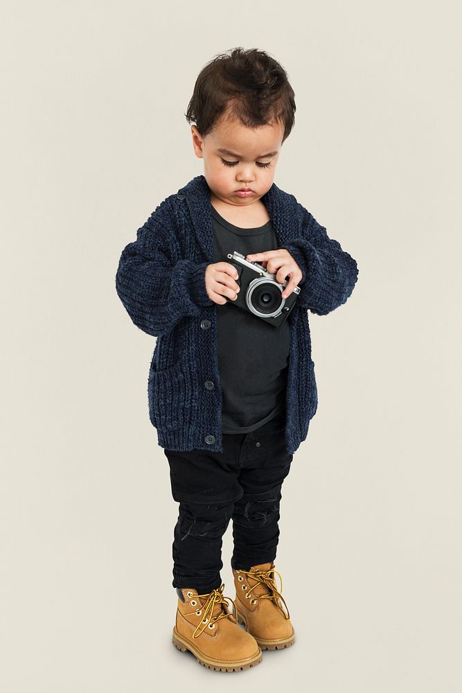 Curious Little Boy Holding Camera Concept