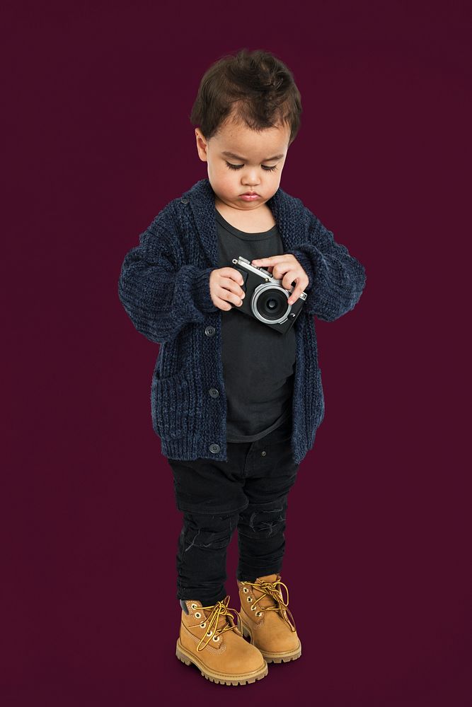 Curious Little Boy Holding Camera Concept