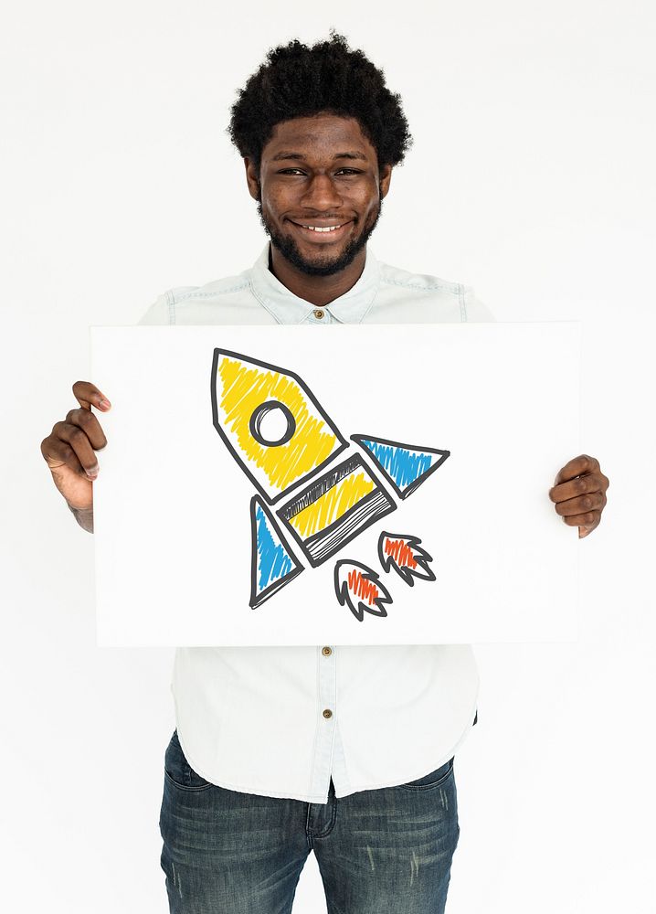 A young man holding a placard with rocketship illustration