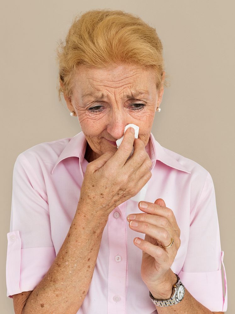 Senior Women Blowing Nose Concept