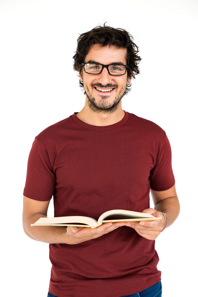 Studio portrait of a guy wearing glasses reading a book