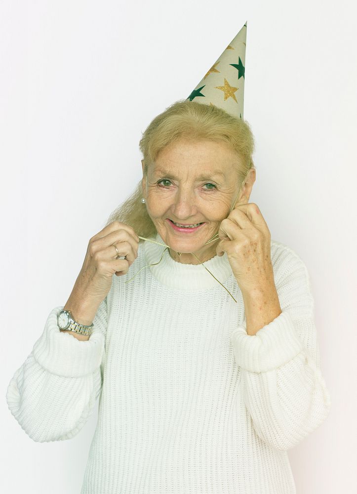 Senior Woman Wearing Party Hat Celebration Studio Portriat