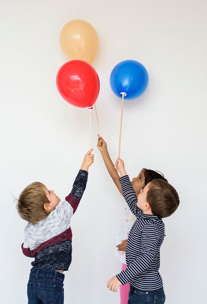 Cute small kids with balloons