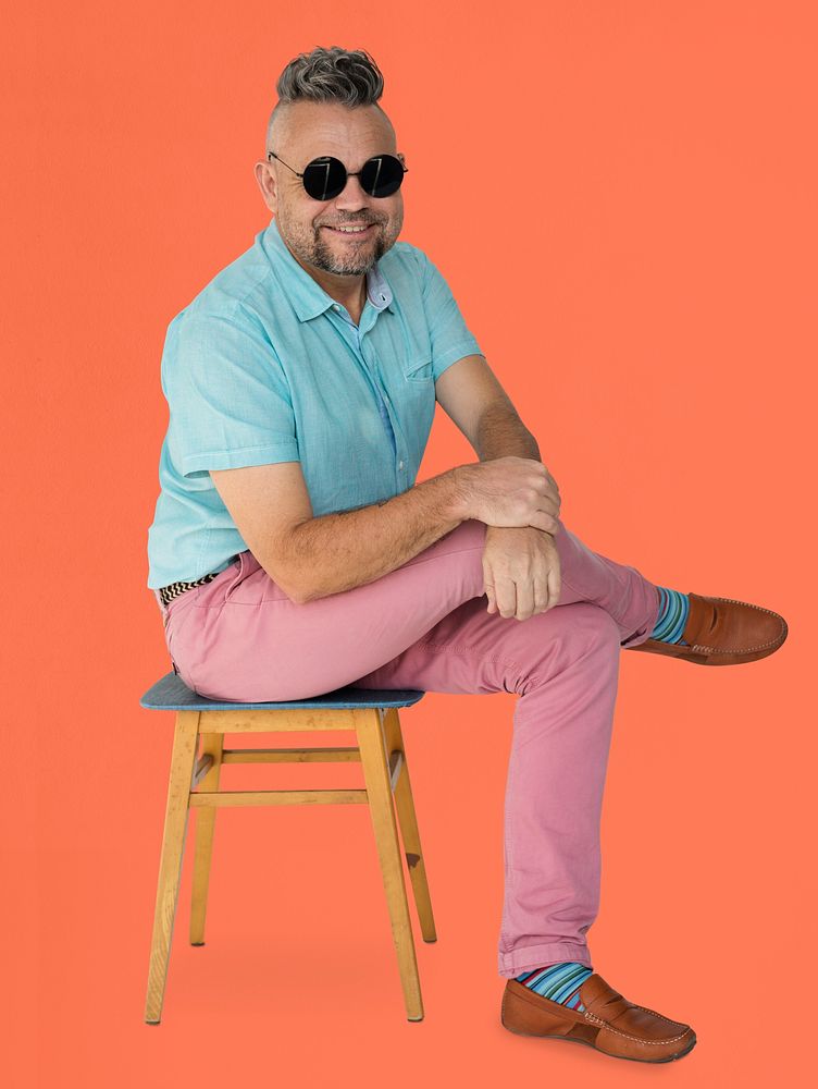 A Man with Sunglasses Sitting on a Chair