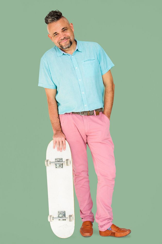 A Man Standing Holding Skateboard