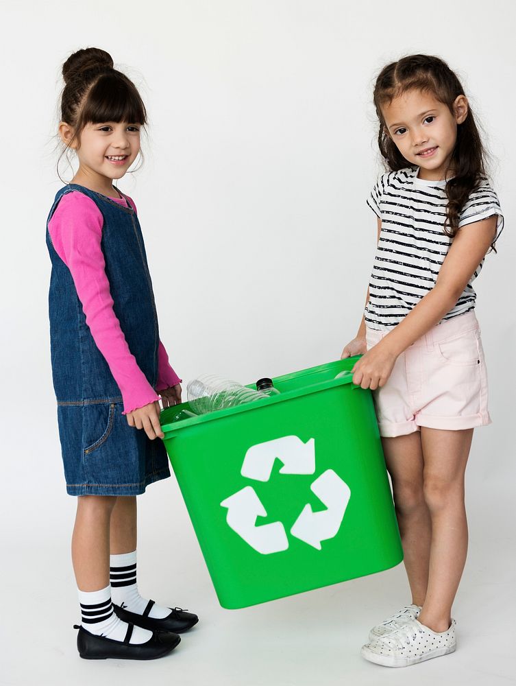 Group of children with a recycling symbol.