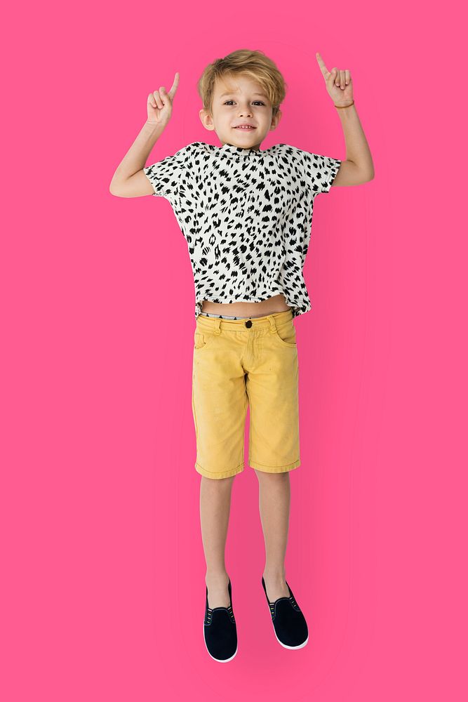 Young blonde boy jumping mid-air portrait