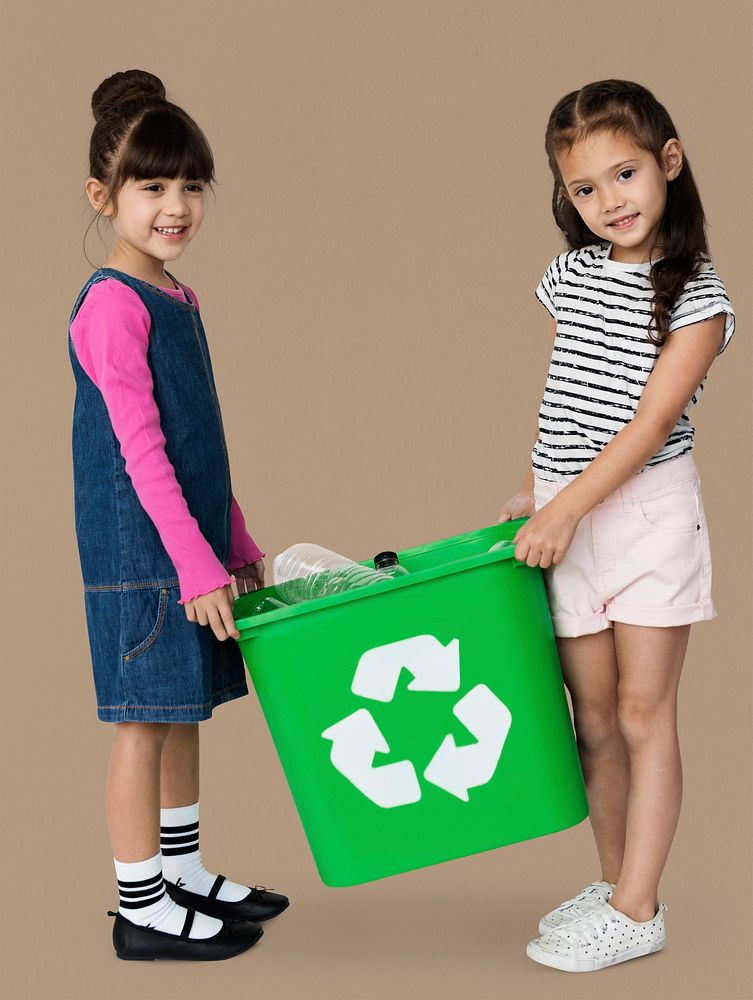 Two girls are holding a recycle bin
