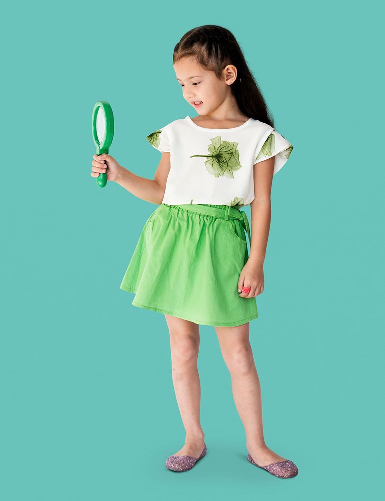 A girl is holding green magnifier