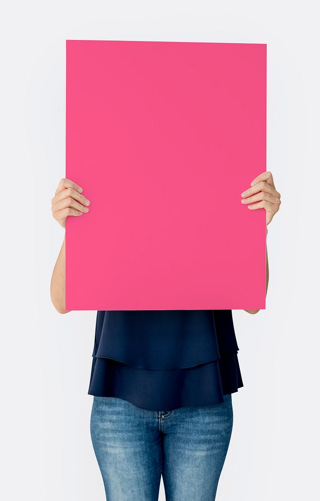 Woman holding blank banner cover face studio portrait