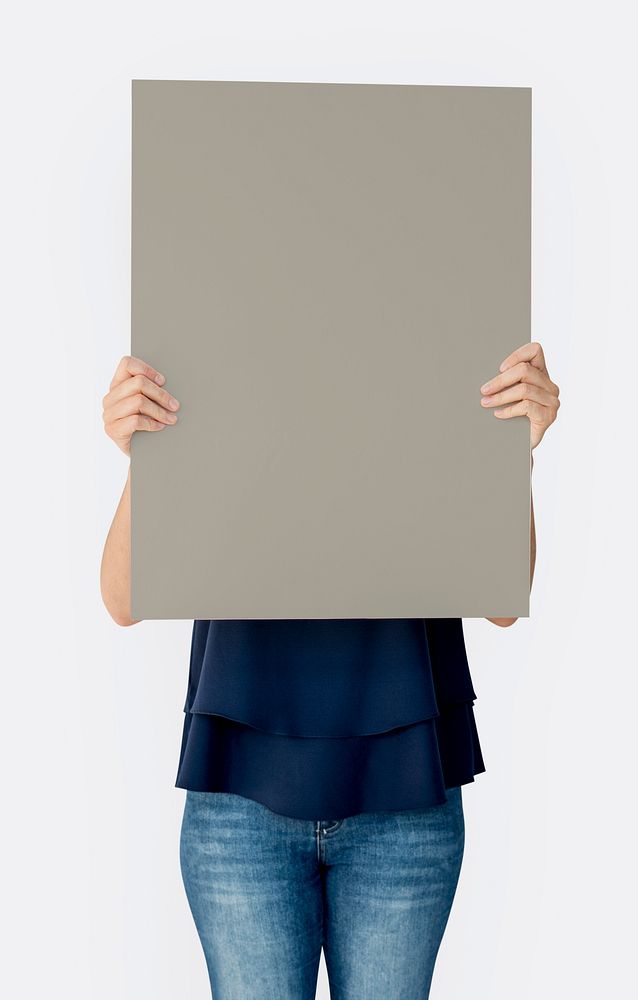 Woman holding blank banner cover face studio portrait