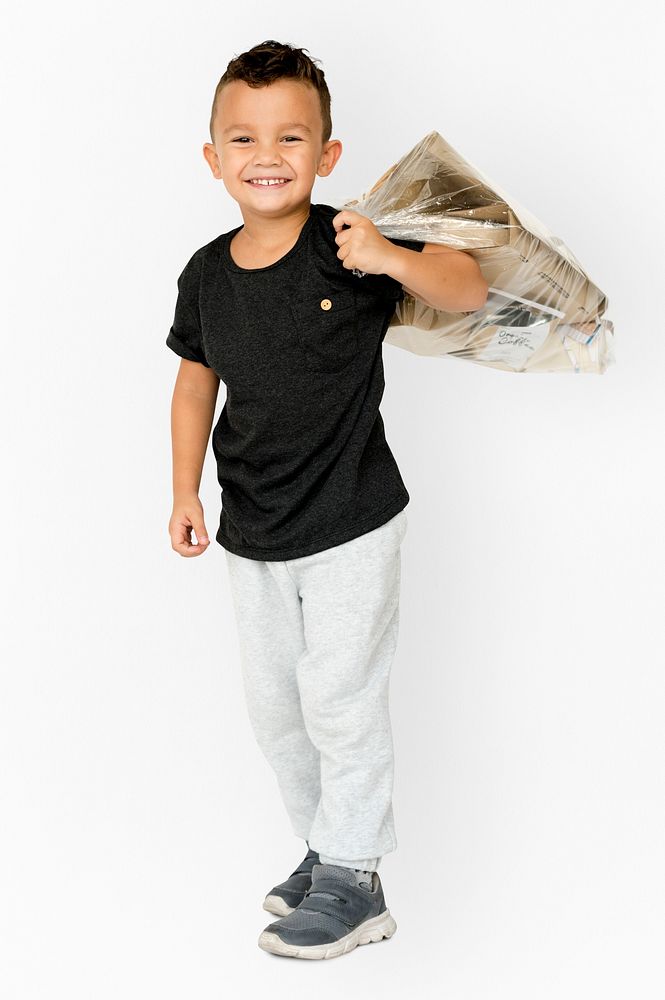 Young boy standing and holding bag posing for photoshoot