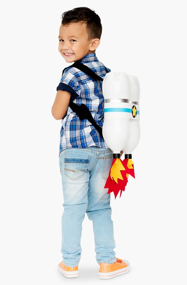 Young cheerful boy with rockets on his back