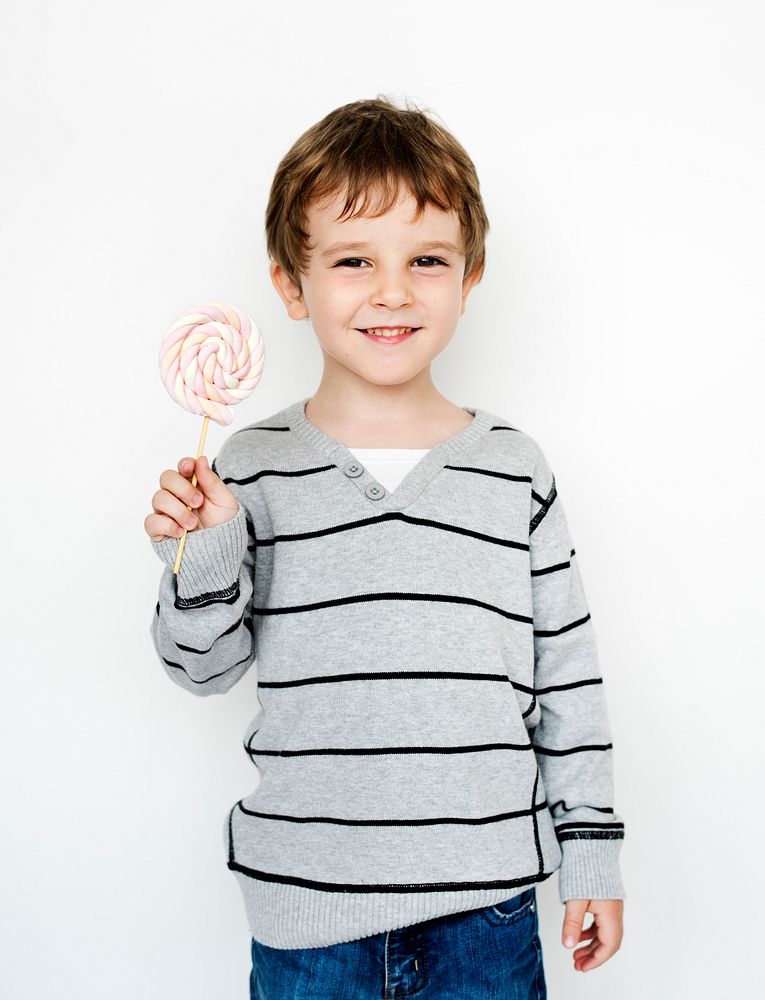 Happiness little boy smiling with lollipop studio portrait