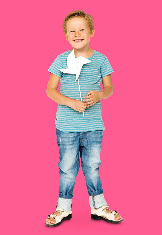 Happiness little boy smiling and holding pinwheel studio portrait
