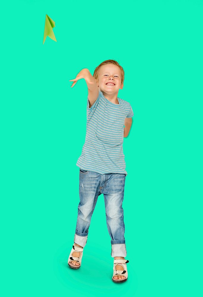 Happiness little boy smiling and flying paper airplane studio portrait