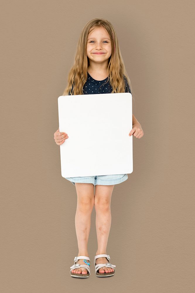 Little girl smiling and holding blank placard