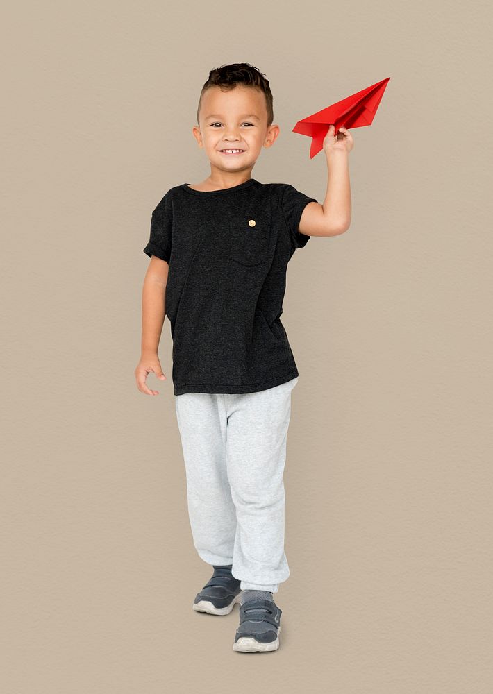 Little Boy Holding Paper Plane Studio Portrait