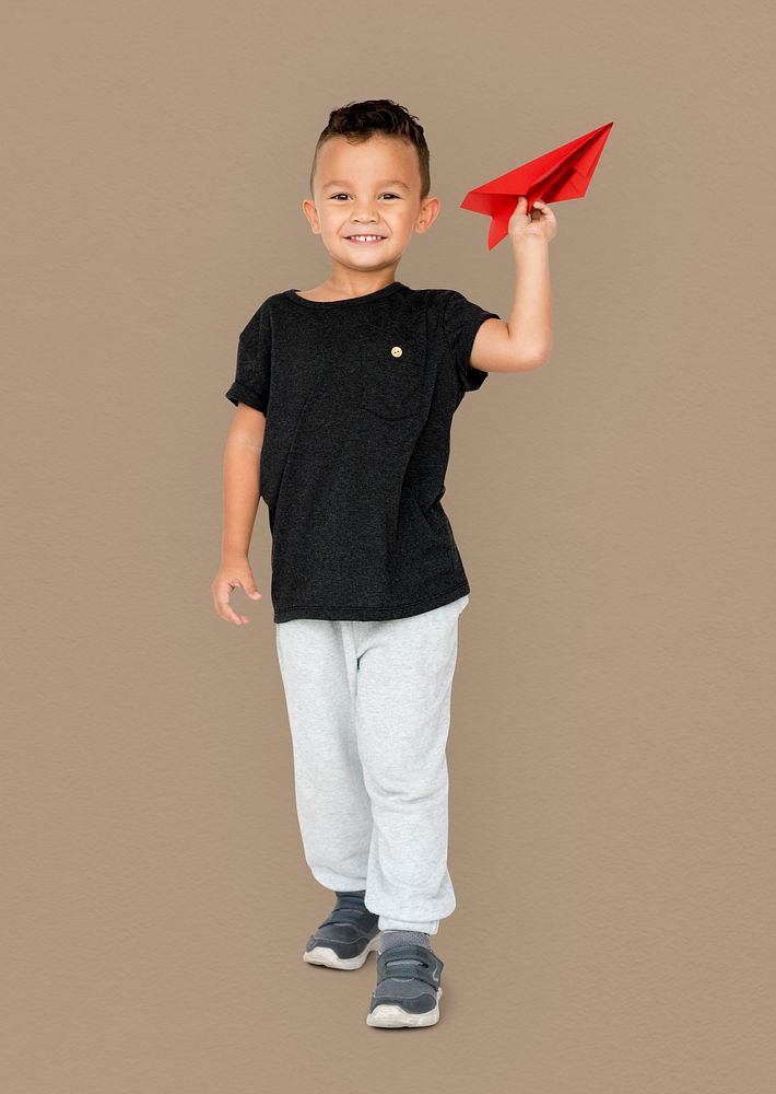 Little Boy Holding Paper Plane Studio Portrait