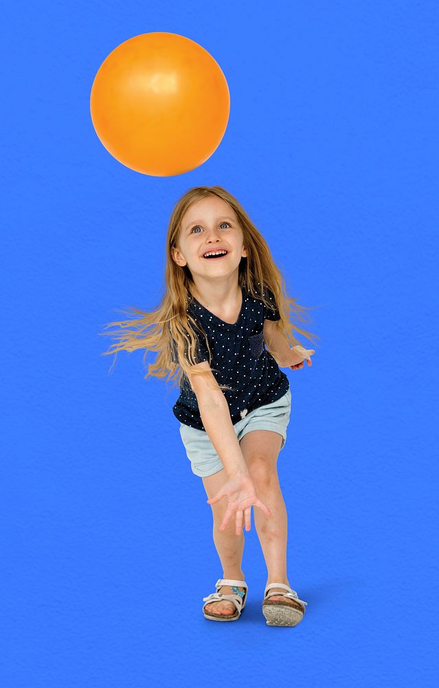 Young caucasian girl with an orange ball