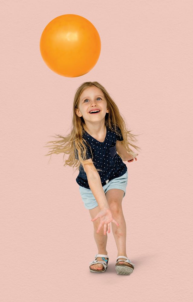 Young caucasian girl with an orange ball