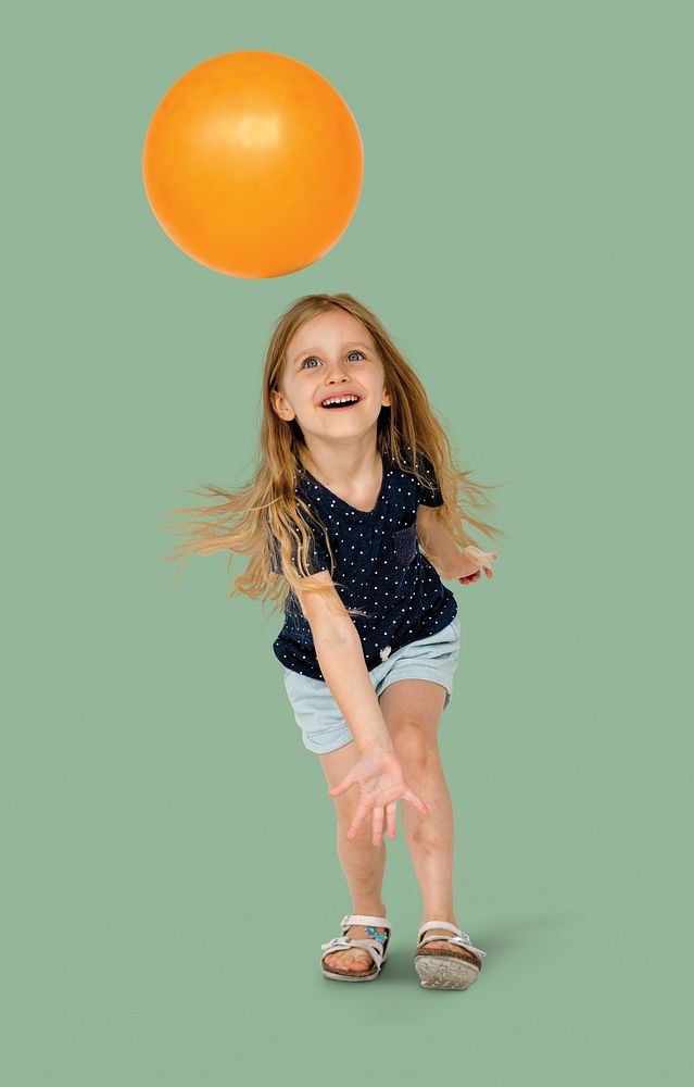 Young caucasian girl with an orange ball