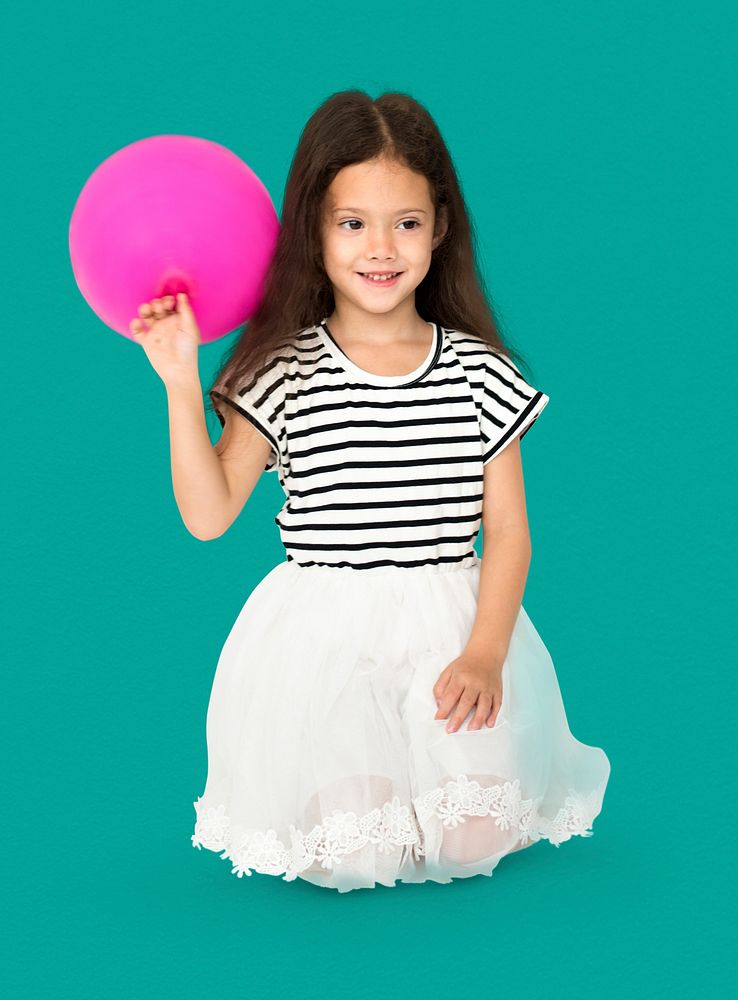 Young girl is sitting holdong pink balloon