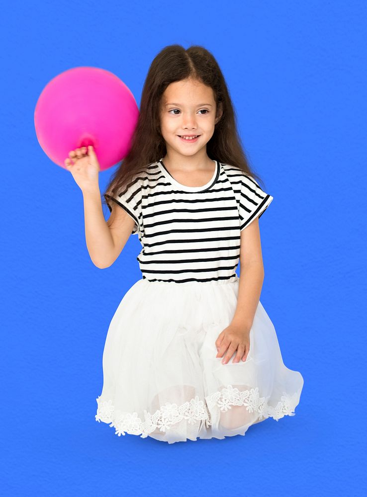 Young girl is sitting holdong pink balloon