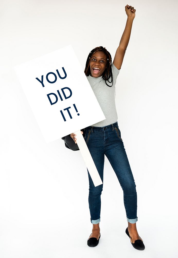 African girl holding you did it banner studio portrait