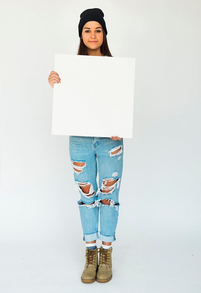 Young adult girl holding blank banner studio portrait