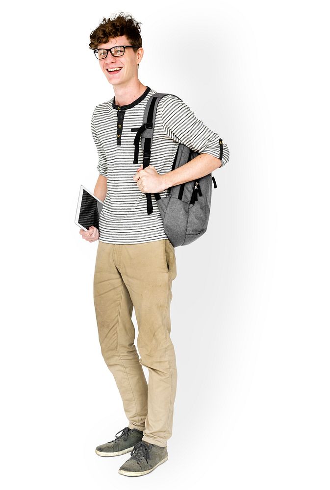 Caucasian young man standing with backpack and tablet