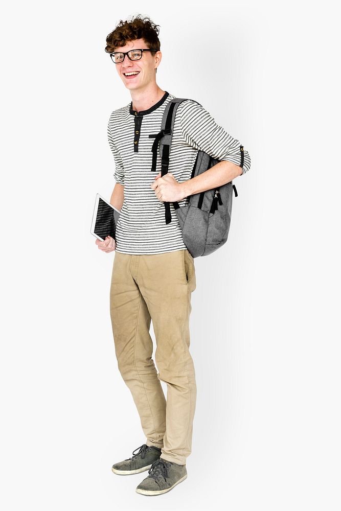 Caucasian young man standing with backpack and tablet