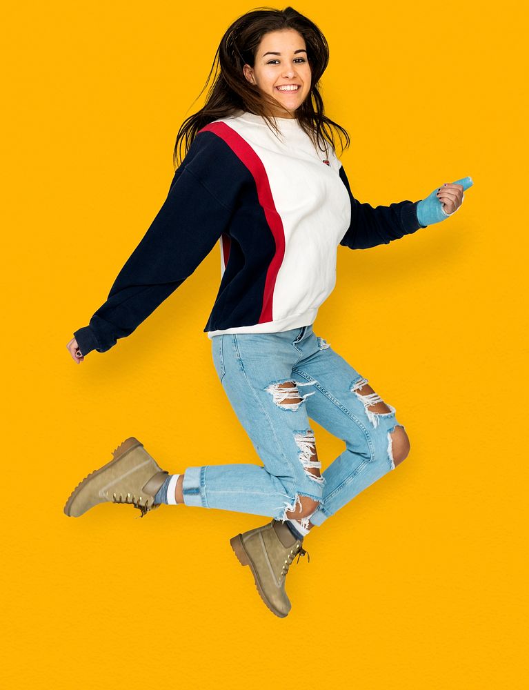 Young Adult Woman Jumping Studio Portrait