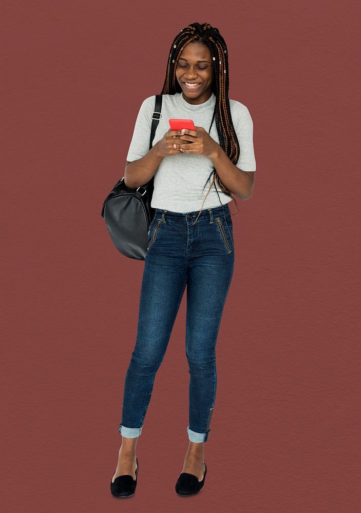 African girl smiling and using mobile phone