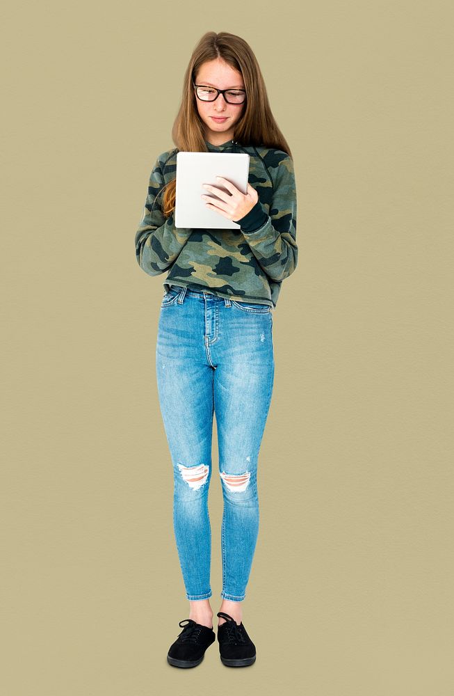 Teenage girl smiling and using digital tablet