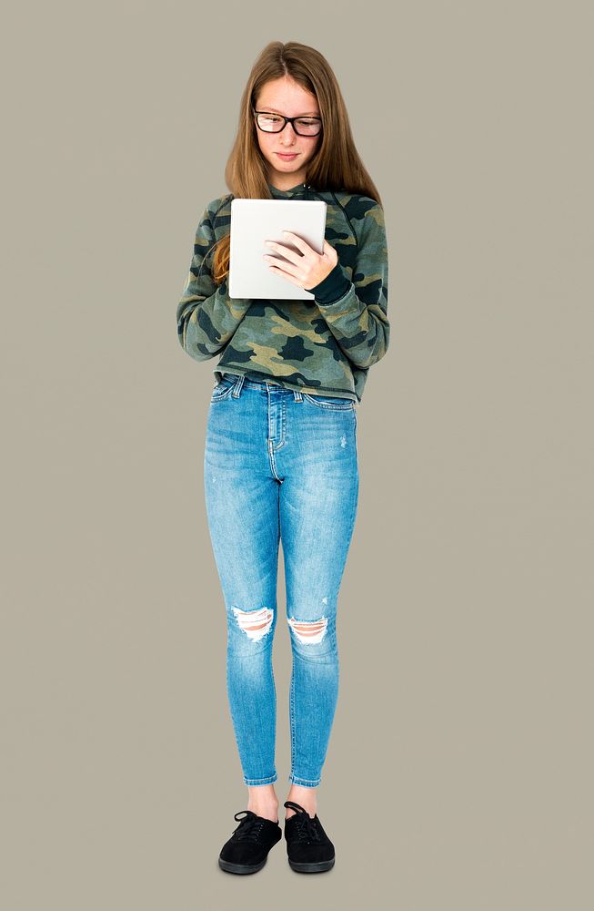 Teenage girl smiling and using digital tablet