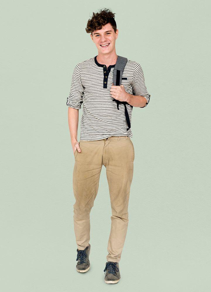 Young adult man smiling and carrying bag