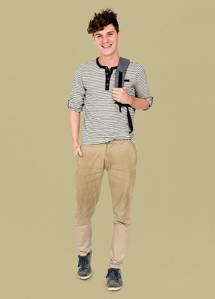 Young adult man smiling and carrying bag
