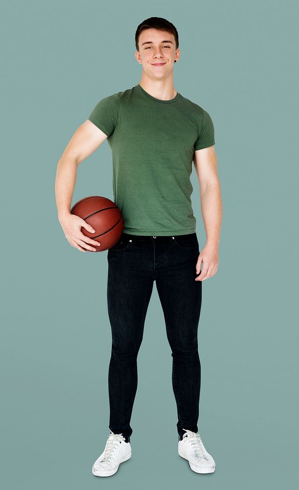 Young adult muscular man holding basketball