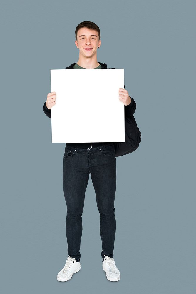 Young adult man holding blank banner