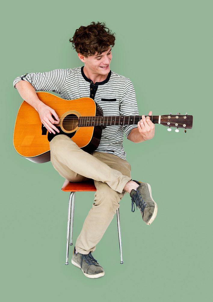 Man guitarist player sitting and playing guitar