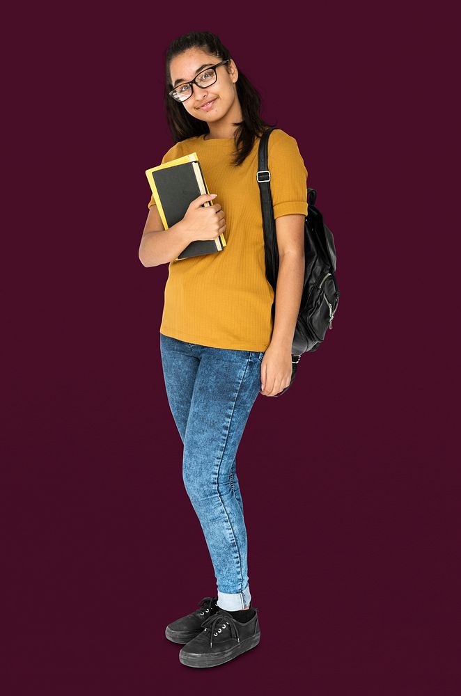 Indian girl student smiling and holding textbook