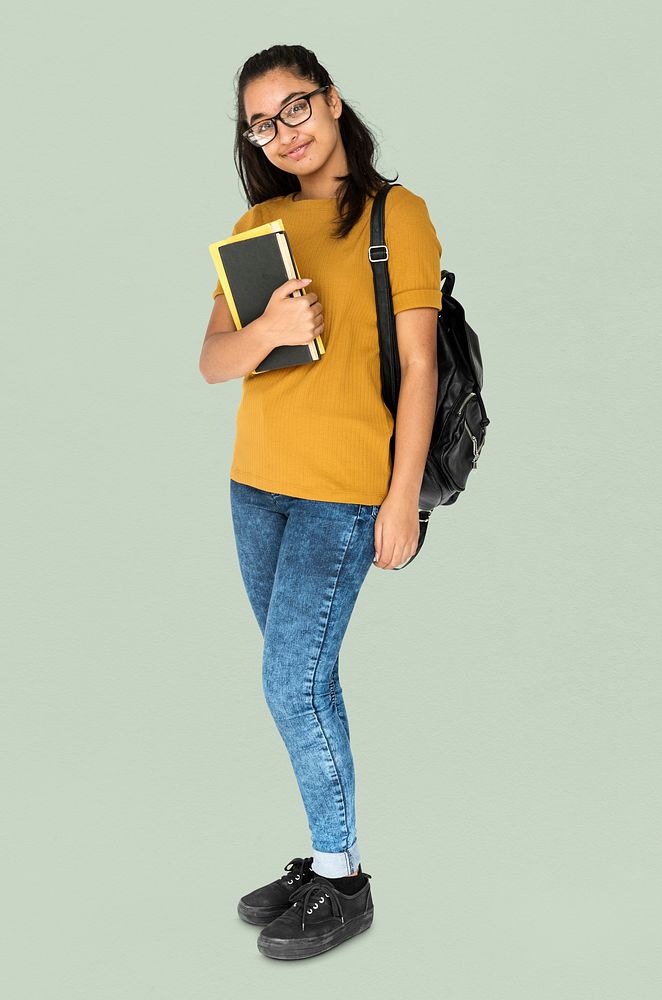 Indian girl student smiling and holding textbook