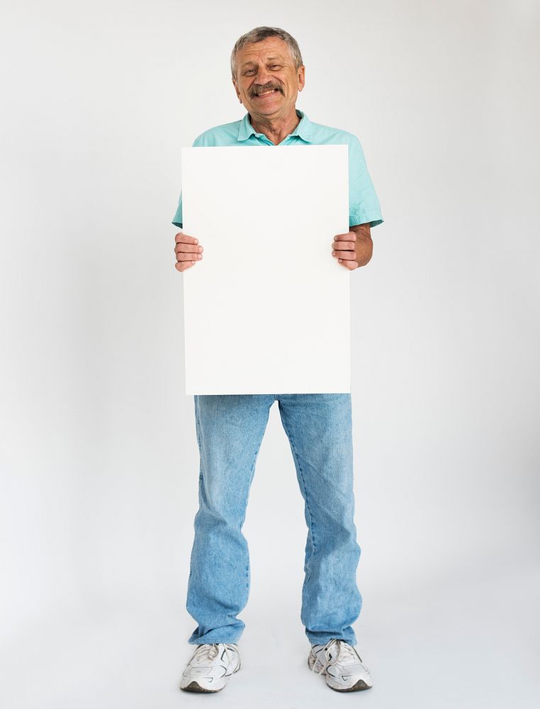 Senior man holding empty board for advertising