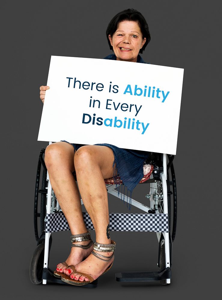Senior adult woman on wheelchair holding motivation banner